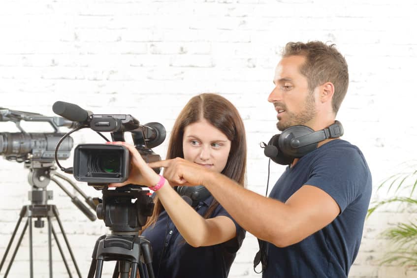 45555122 - a cameraman and a young woman with a movie camera