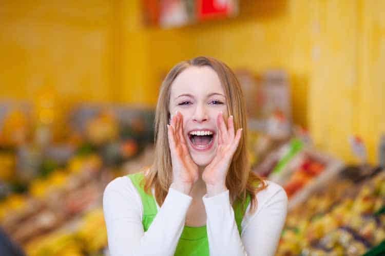 woman shouting offers on grocery store