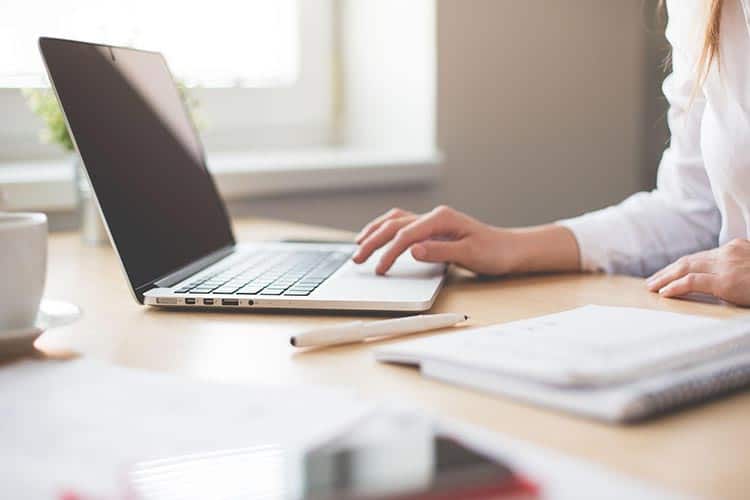 woman typing on laptop