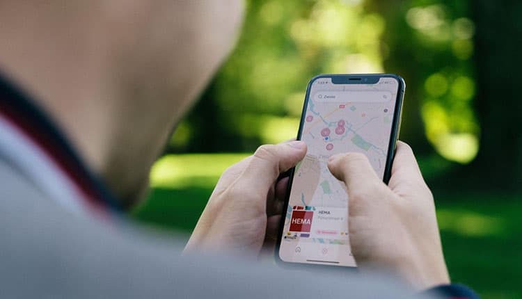 A man is using his phone to look at a map.