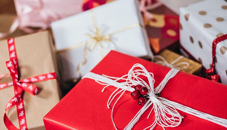 A group of red and white gift boxes on a table.