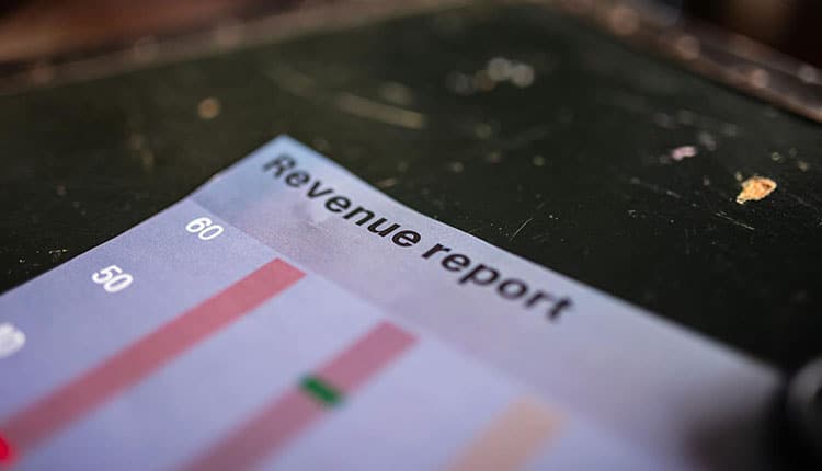 Close-up of a printed revenue report with bar graphs.