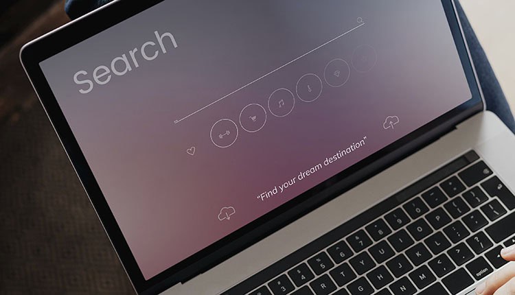 Laptop screen displaying a search interface with icons for different categories, under the text "Find your dream destination.