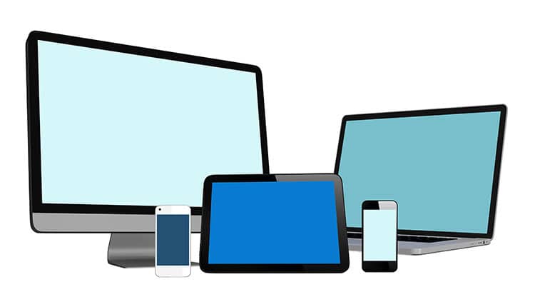 An illustration of five electronic devices: a desktop monitor, a laptop, a tablet, and two smartphones, all with blank screens on a white background.