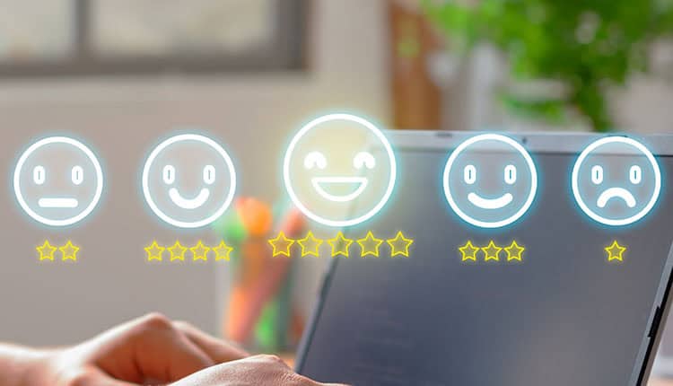 five glowing emoji faces above the screen, each with a different expression and star rating, representing a feedback or rating system