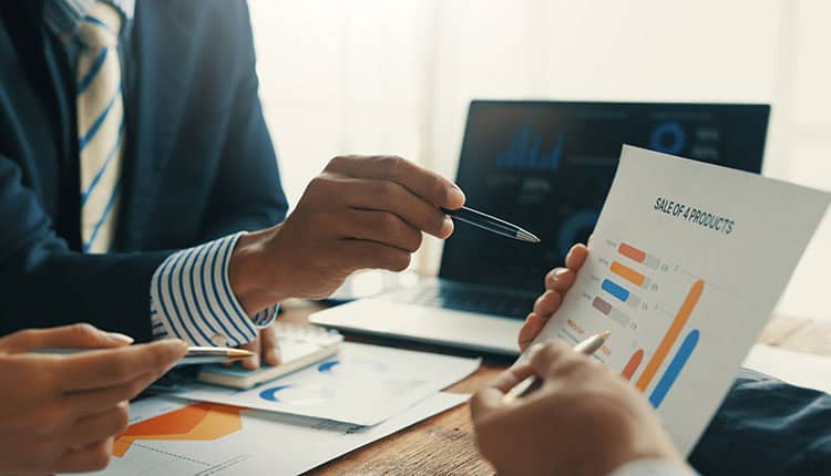 Business people analyzing financial charts and graphs