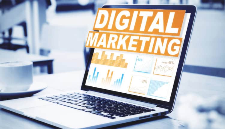 A laptop displays data charts and the words "DIGITAL MARKETING"
